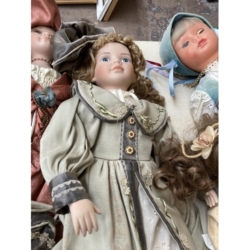 388 - Seven dolls, five porcelain and two plastic