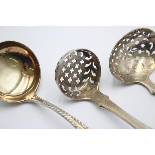 1300 - Three pieces of antique hallmarked sterling silver, two sugar sifters and one ladle - approx. gross ... 