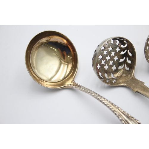 1300 - Three pieces of antique hallmarked sterling silver, two sugar sifters and one ladle - approx. gross ... 