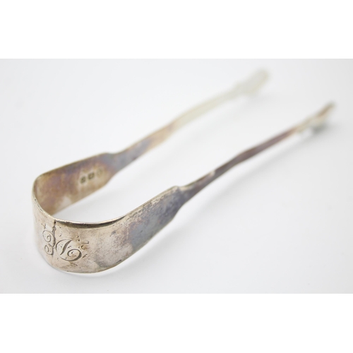 1303 - Two pairs of Georgian hallmarked sterling silver sugar tongs - approx. gross weight 66 grams