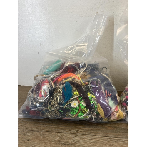 413 - Four bags containing a large quantity of costume jewellery