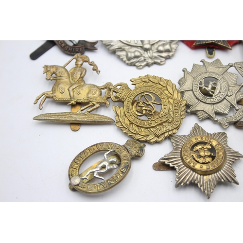 1393 - Ten military cap badges to include KOSB, Bedforshire & Hertfordshire, Hussars etc.