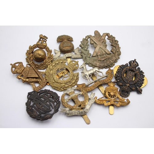 1394 - Ten military cap badges to include Royal Marines, Irish, Royal Warwickshire etc.