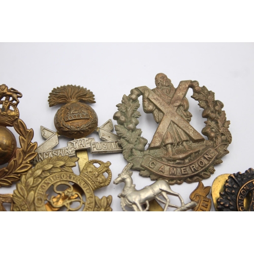 1394 - Ten military cap badges to include Royal Marines, Irish, Royal Warwickshire etc.