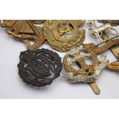 1394 - Ten military cap badges to include Royal Marines, Irish, Royal Warwickshire etc.