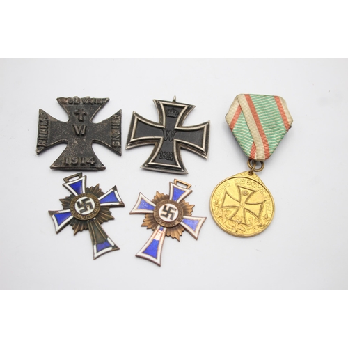 1395 - Five German medals to include WWI Iron Cross, Honorary Medal of the Legion etc.