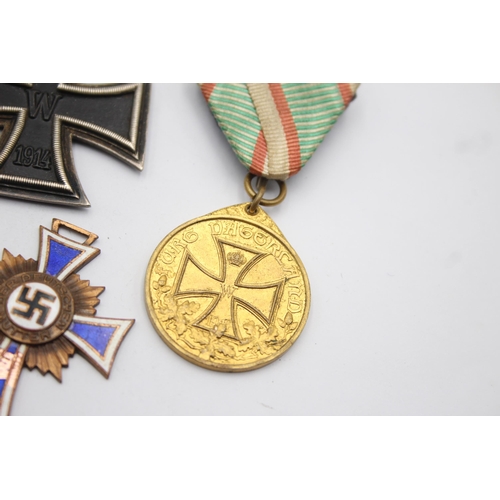 1395 - Five German medals to include WWI Iron Cross, Honorary Medal of the Legion etc.