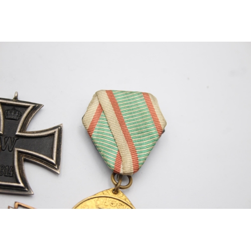 1395 - Five German medals to include WWI Iron Cross, Honorary Medal of the Legion etc.