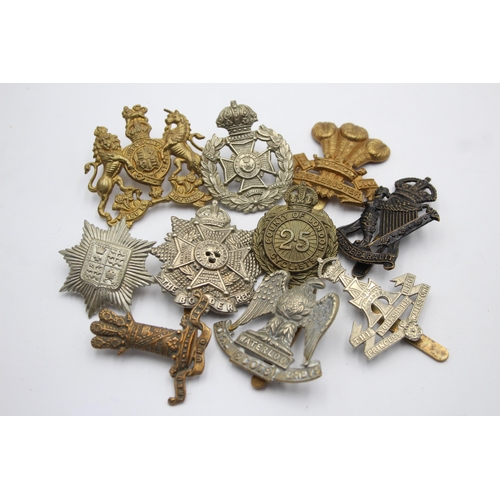 1401 - Ten military cap badges to include Border Regiment, Yorkshire Regiment etc.