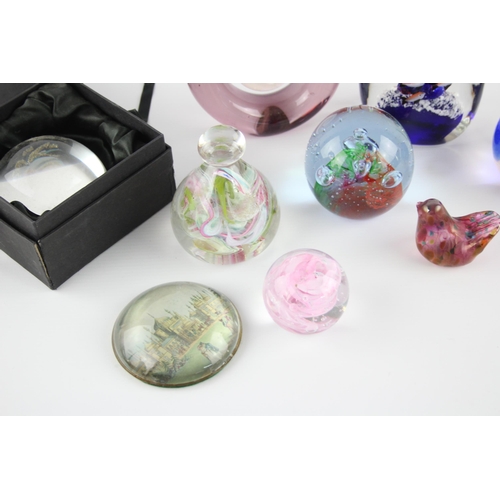 326E - A collection of paperweights to include Isle of Wight Glass, Royal Pavillion etc.