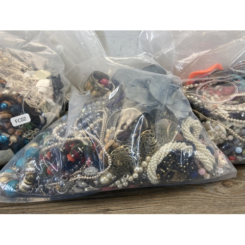 407 - Three bags containing a large quantity of costume jewellery