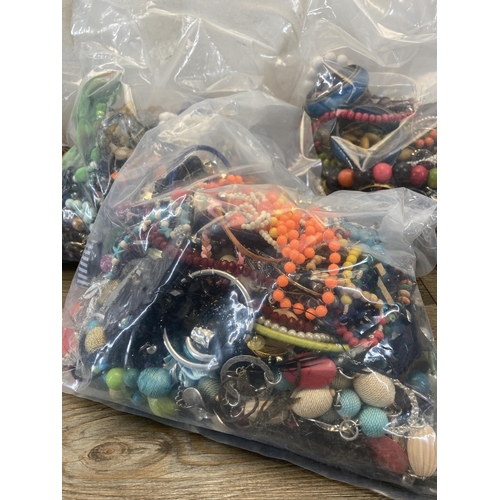 408 - Four bags containing a large quantity of costume jewellery