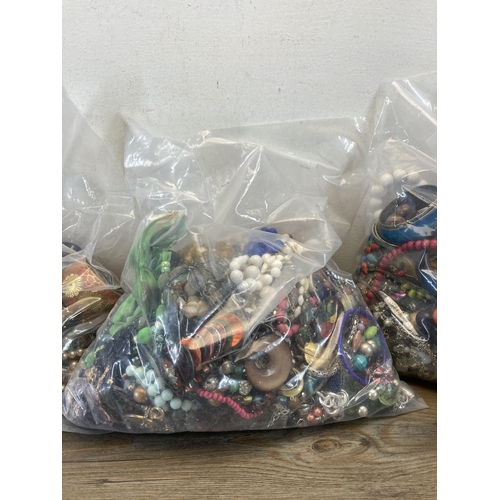 408 - Four bags containing a large quantity of costume jewellery