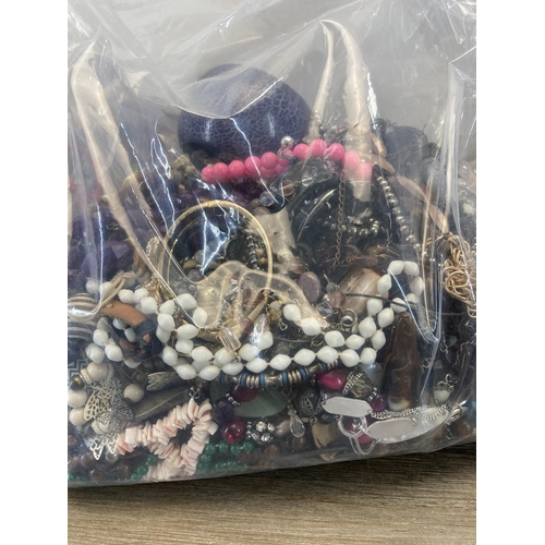 412 - Four bags containing a large quantity of costume jewellery