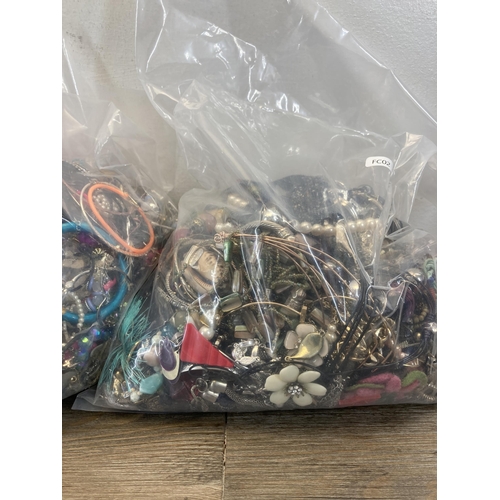 413 - Four bags containing a large quantity of costume jewellery