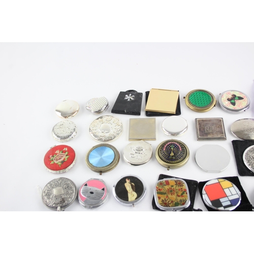 425 - A large collection of compact mirrors to include Celtic, Mackintosh, St Justin etc.