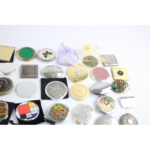 425 - A large collection of compact mirrors to include Celtic, Mackintosh, St Justin etc.