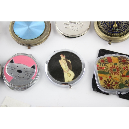 425 - A large collection of compact mirrors to include Celtic, Mackintosh, St Justin etc.