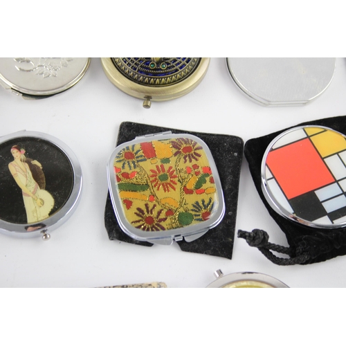 425 - A large collection of compact mirrors to include Celtic, Mackintosh, St Justin etc.