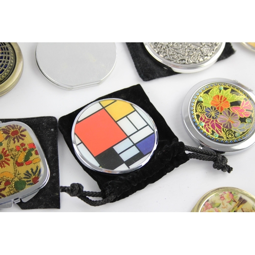 425 - A large collection of compact mirrors to include Celtic, Mackintosh, St Justin etc.