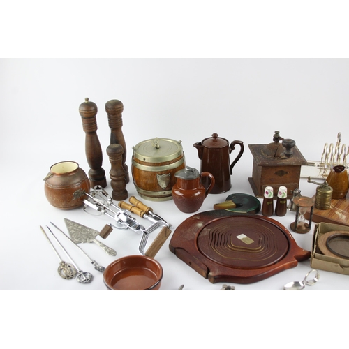 544 - A collection of kitchenalia to include biscuit barrel, cheese board, toast rack etc.