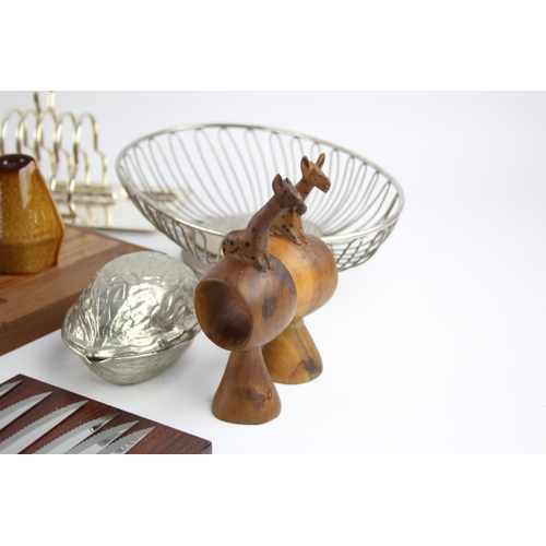 544 - A collection of kitchenalia to include biscuit barrel, cheese board, toast rack etc.