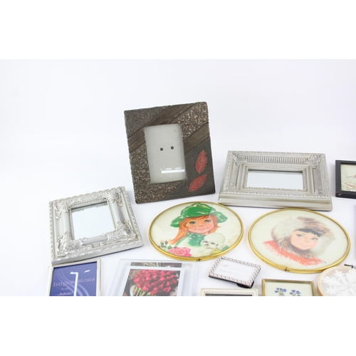 545 - A collection of wall art and frames to include framed mirrors, prints etc.