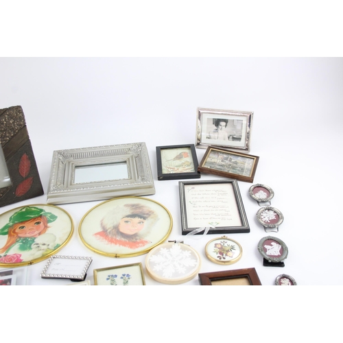 545 - A collection of wall art and frames to include framed mirrors, prints etc.