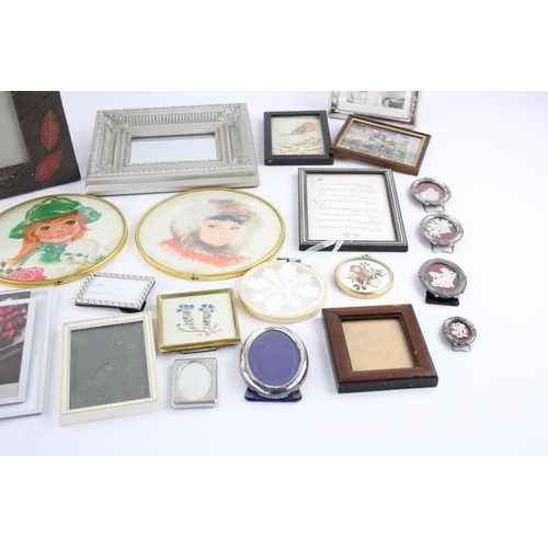 545 - A collection of wall art and frames to include framed mirrors, prints etc.