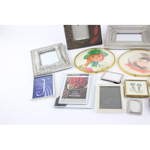 545 - A collection of wall art and frames to include framed mirrors, prints etc.