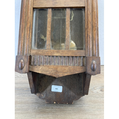 485 - An oak cased chiming wall clock with pendulum and key - approx. 60cm high