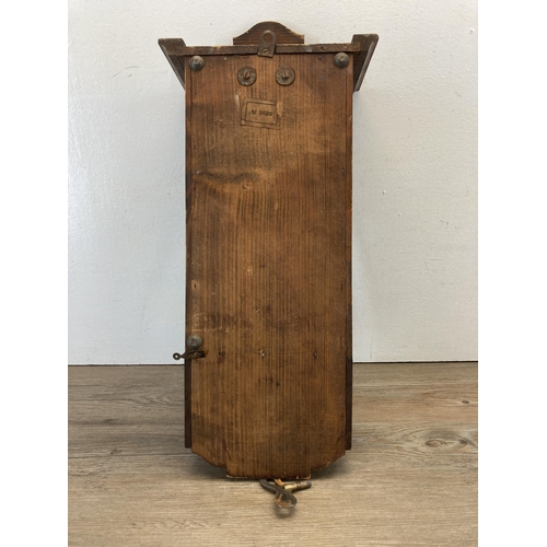 485 - An oak cased chiming wall clock with pendulum and key - approx. 60cm high