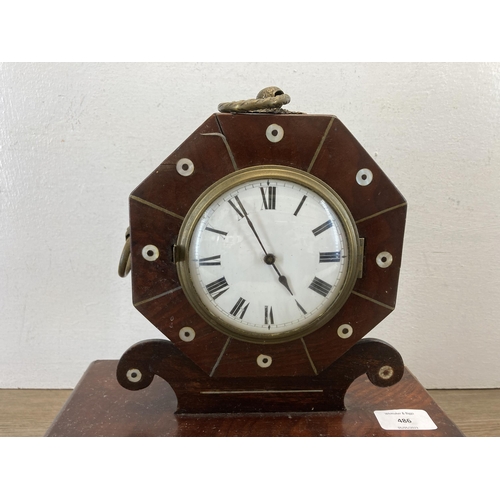 486 - A Regency rosewood mantle clock with mother of pearl and brass inlay, white enamel face and key, cir... 