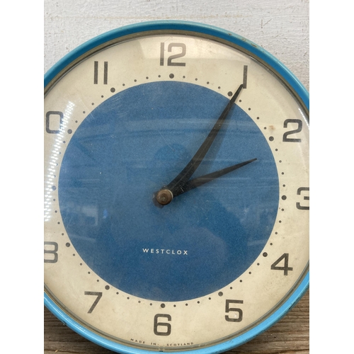 493 - A mid 20th century Westclox blue and white enamel circular kitchen wall clock - approx. 18cm diamete... 