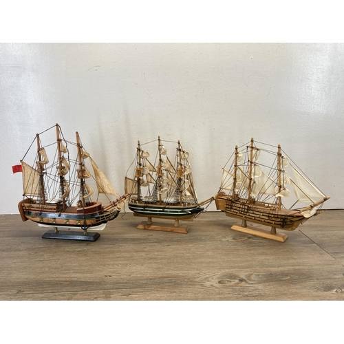 506 - Three wooden model ships to include Cutty Sark, HMS Bounty etc. - largest approx. 33cm high