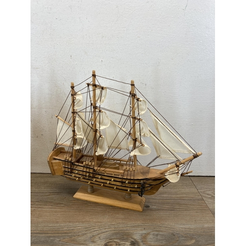 506 - Three wooden model ships to include Cutty Sark, HMS Bounty etc. - largest approx. 33cm high