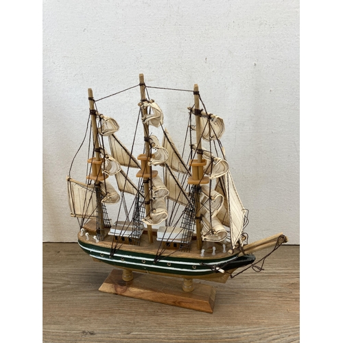 506 - Three wooden model ships to include Cutty Sark, HMS Bounty etc. - largest approx. 33cm high