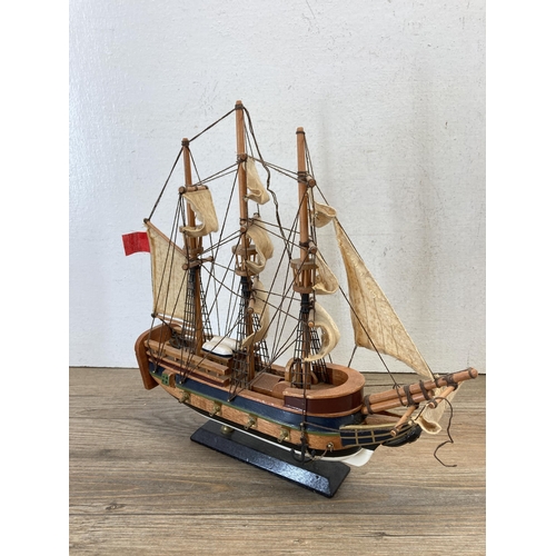 506 - Three wooden model ships to include Cutty Sark, HMS Bounty etc. - largest approx. 33cm high