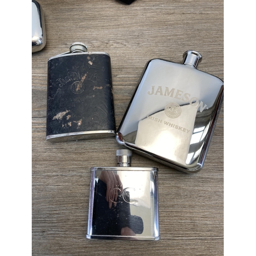 517 - A collection of hipflasks to include John Jameson, Remy Martin etc.