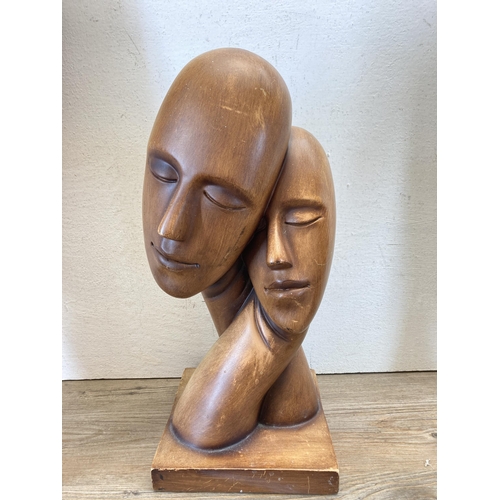 519 - Four items, two African carved hardwood busts - approx. 51cm high, one modern abstract resin bust an... 