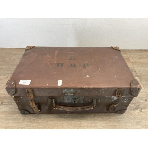 523 - A vintage brown leather suitcase containing fishing accessories to include three mahogany and brass ... 