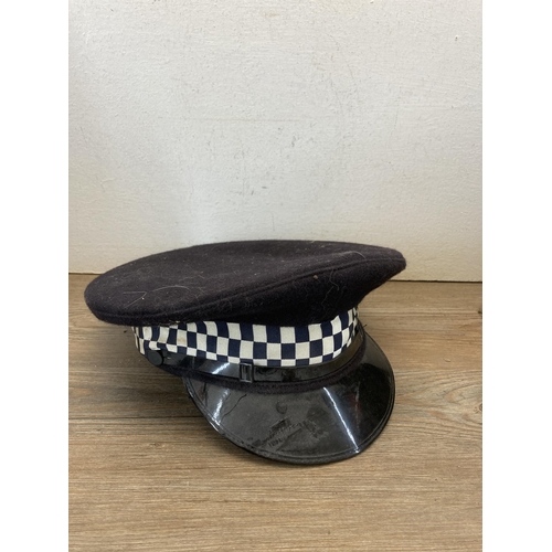 540 - Three police helmets and caps, two with Cheshire Constabulary badges