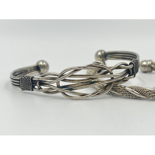 1193 - Four white metal cuff bracelets to include one stamped .925 - approx. gross weight 70 grams