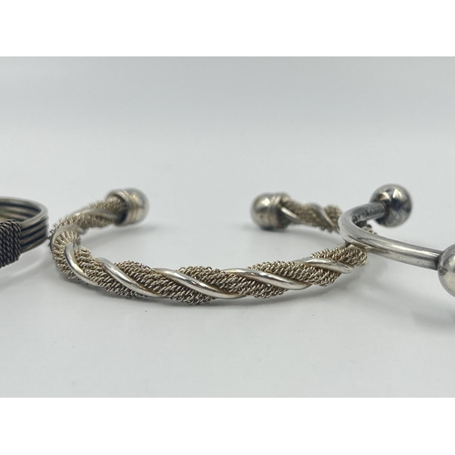 1193 - Four white metal cuff bracelets to include one stamped .925 - approx. gross weight 70 grams