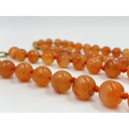 1183 - Two Art Deco carnelian beaded necklaces, one with 9ct gold clasp - approx. gross weight 115 grams