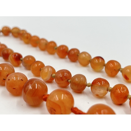 1183 - Two Art Deco carnelian beaded necklaces, one with 9ct gold clasp - approx. gross weight 115 grams