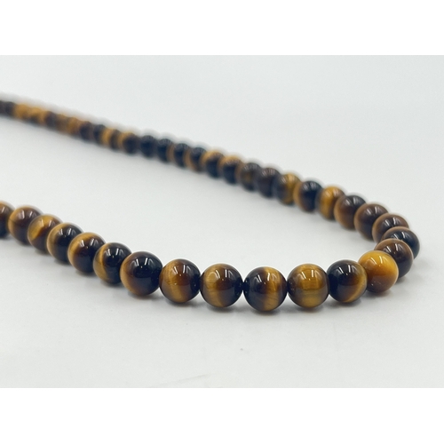 1189 - Two pieces of tiger's eye jewellery, one beaded necklace with white metal clasp and one pair of 9ct ... 