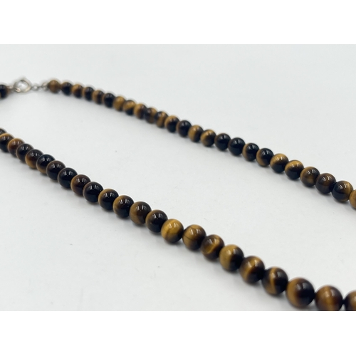 1189 - Two pieces of tiger's eye jewellery, one beaded necklace with white metal clasp and one pair of 9ct ... 