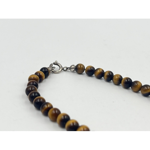 1189 - Two pieces of tiger's eye jewellery, one beaded necklace with white metal clasp and one pair of 9ct ... 