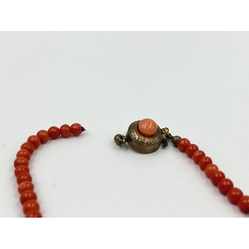 1190 - Four pieces of coral jewellery to include a pair of stamped 18ct gold earrings - approx. gross weigh... 